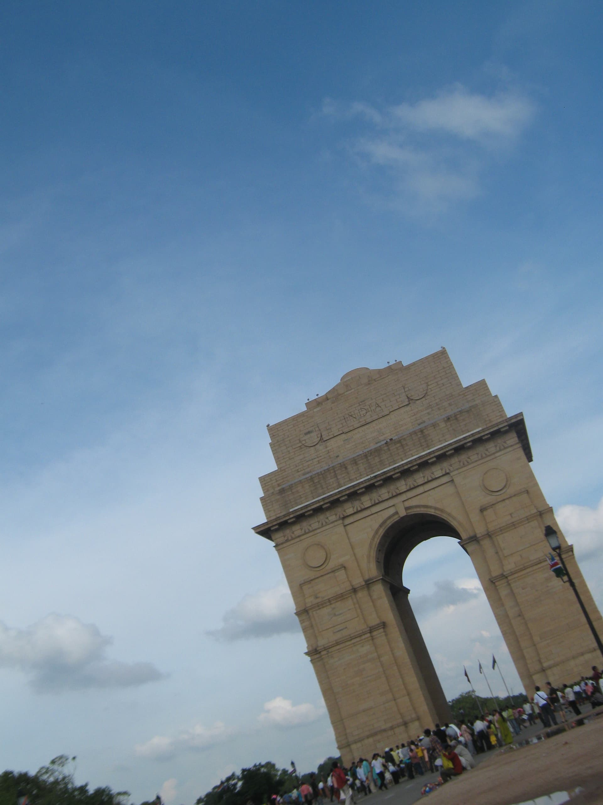 India Gate, New Delhi — the 42-metre-high war memorial arch on Kartavya Path, photographed from a distance showing the full sandstone monument.