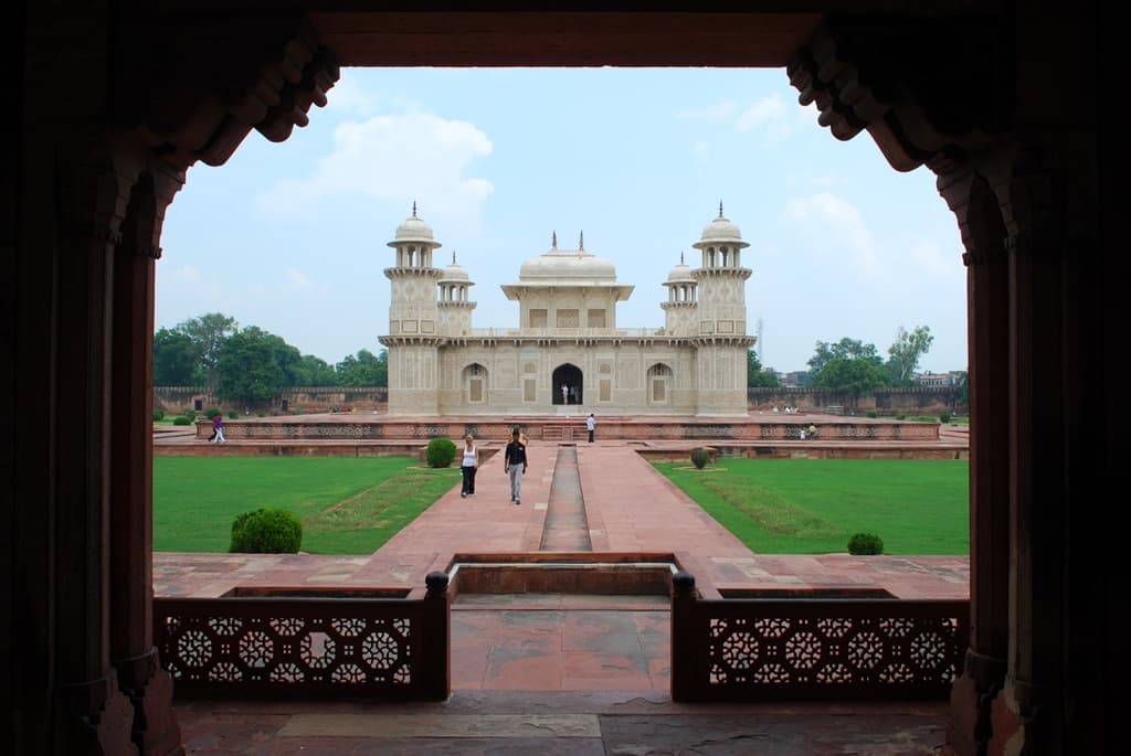 Tomb of I'timad-ud-Daula (Baby Taj), Agra — the white marble mausoleum seen from the garden gate, showing the ornate pietra dura facade.