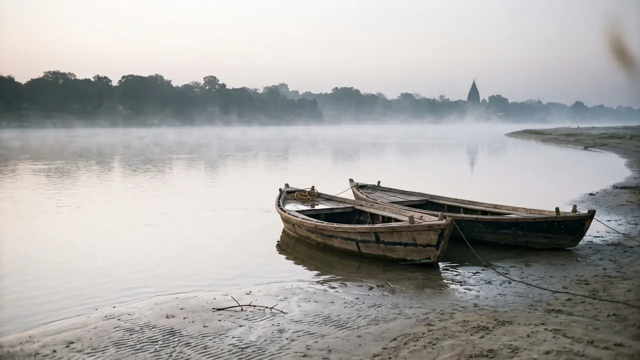A wide river bend at dawn with two unpainted wooden boats on a sandbank, mist over the water and a distant temple spire.
